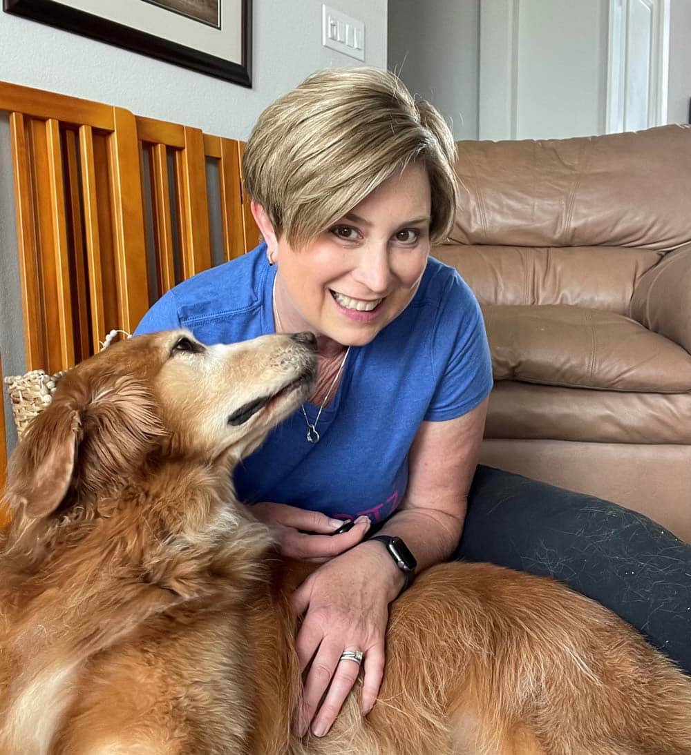 Jennifer giving a dog a cuddle.